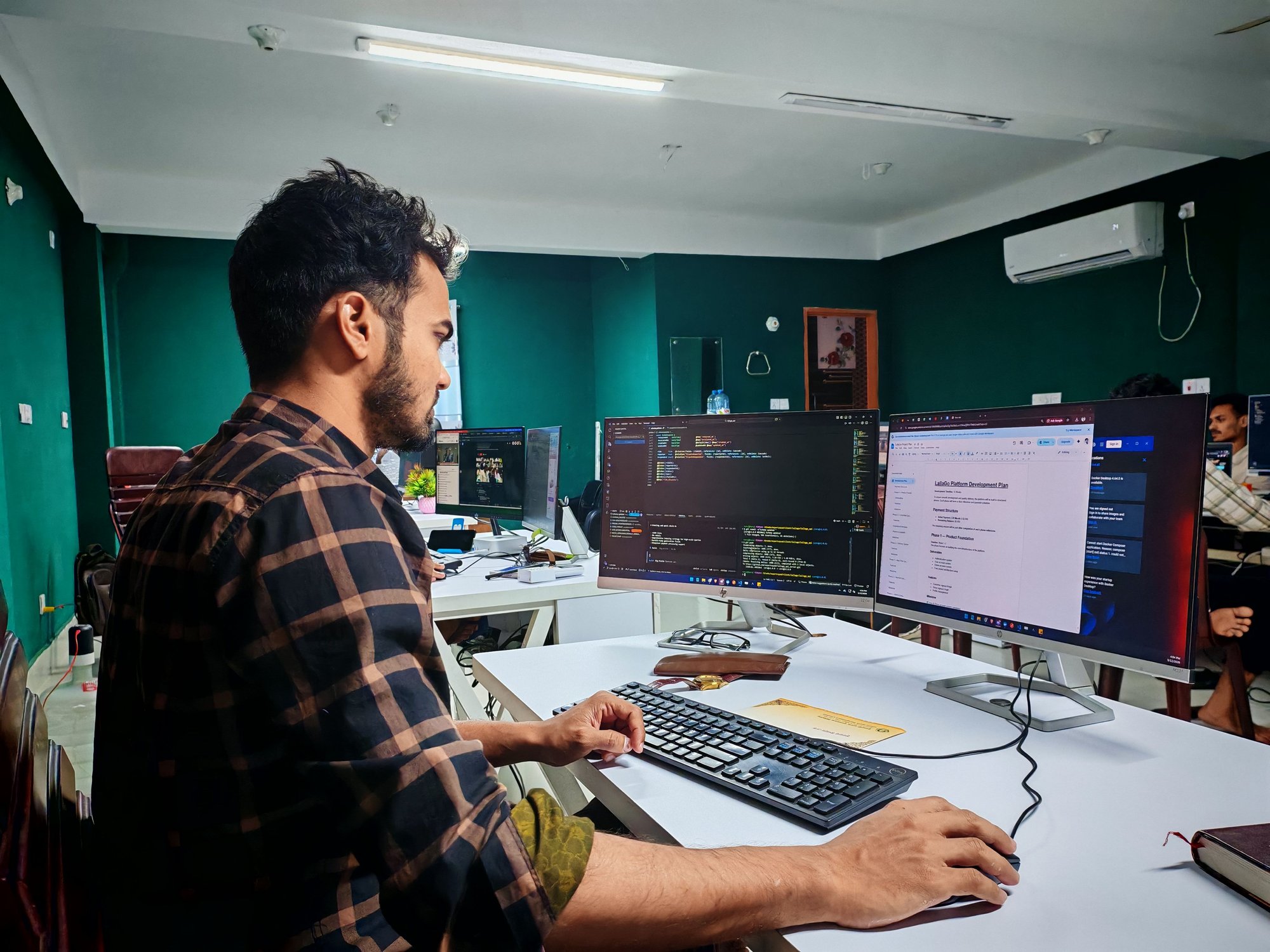 A 1024 engineer working through a build across two monitors of code
